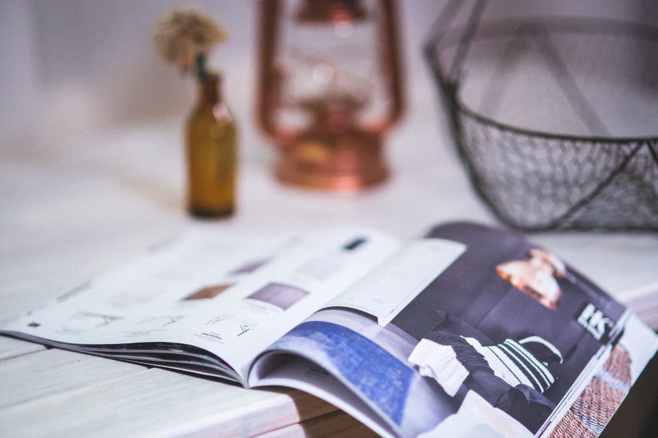 An open print magazine on a table, pages spread