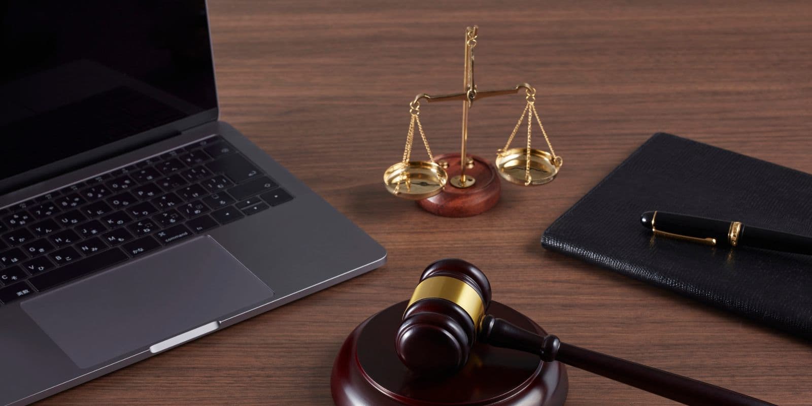 A laptop, scales of justice and a gavel on a desk